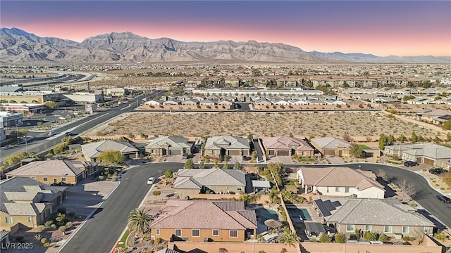 aerial view at dusk featuring a mountain view