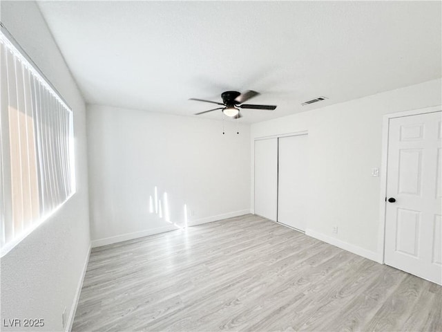 empty room with light wood-type flooring and ceiling fan