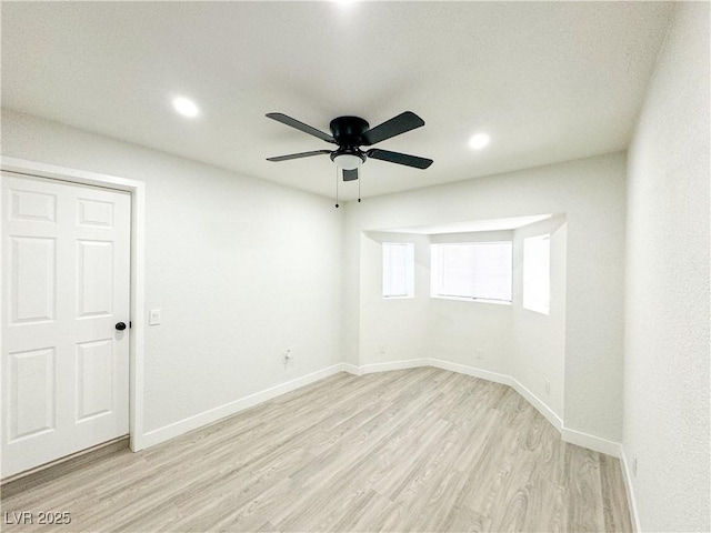 spare room featuring ceiling fan and light hardwood / wood-style flooring