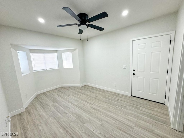 empty room featuring light wood-type flooring and ceiling fan