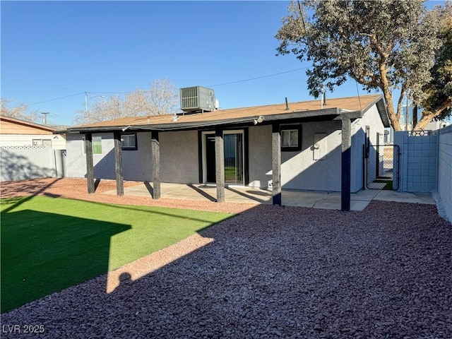 back of property featuring central AC and a patio