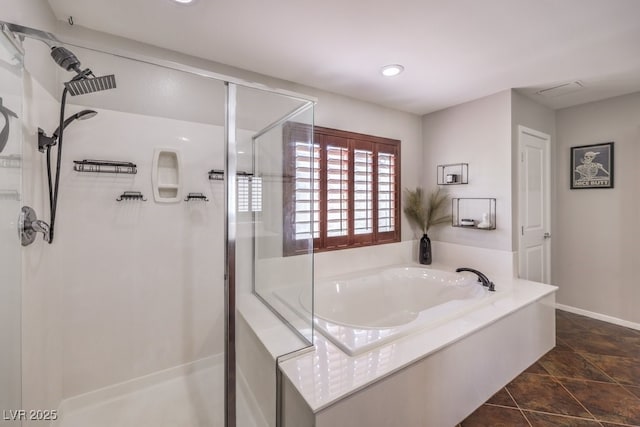 bathroom featuring shower with separate bathtub