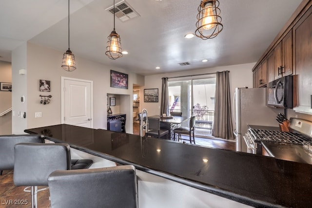 kitchen with pendant lighting and gas range