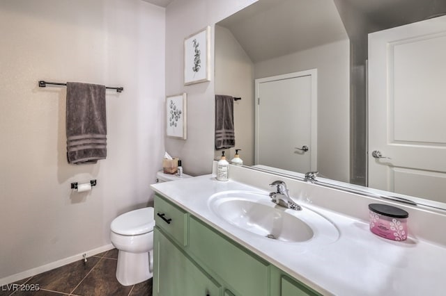 bathroom featuring toilet, vanity, and tile patterned flooring