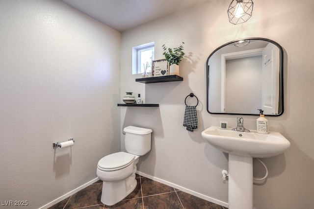 bathroom with toilet and tile patterned floors