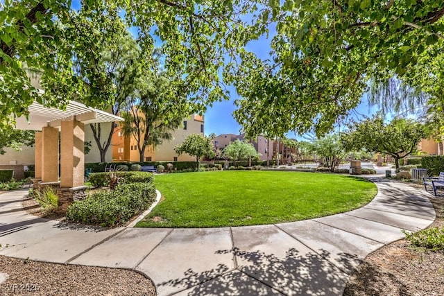 view of community with a yard and a pergola