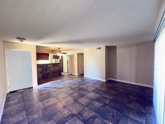 unfurnished living room with ceiling fan