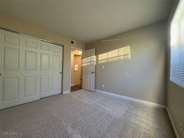 unfurnished bedroom featuring carpet floors and a closet