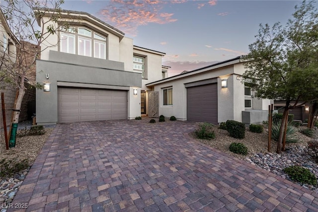 view of front of property featuring decorative driveway and stucco siding