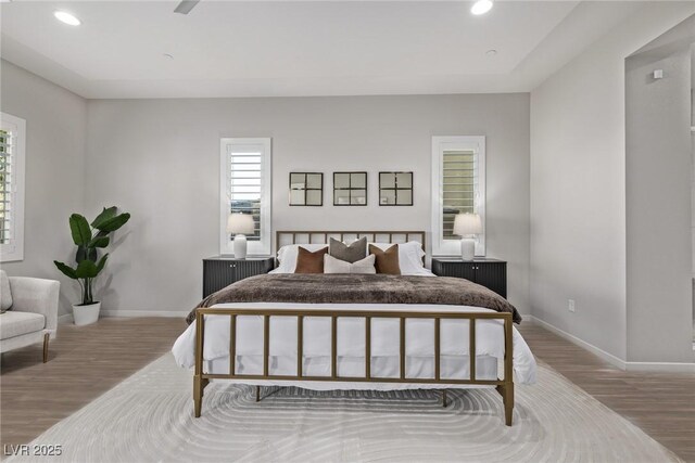 bedroom featuring recessed lighting, wood finished floors, and baseboards