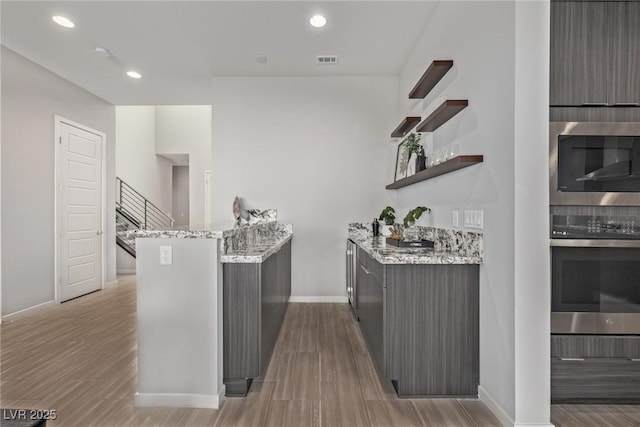 bar featuring appliances with stainless steel finishes, stairway, visible vents, and recessed lighting