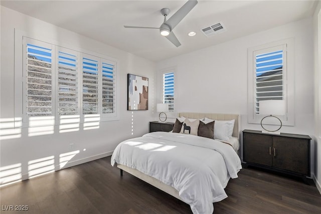 bedroom featuring a ceiling fan, baseboards, visible vents, and wood finished floors