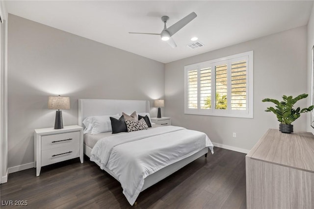 bedroom with a ceiling fan, dark wood finished floors, visible vents, and baseboards