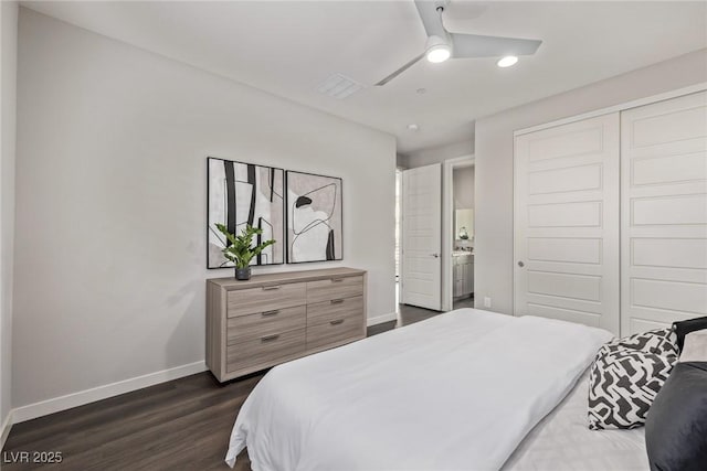 bedroom with a closet, dark wood finished floors, a ceiling fan, and baseboards