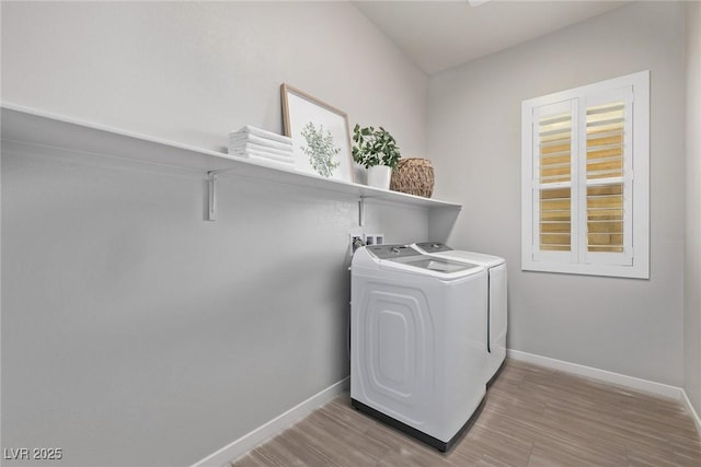 washroom featuring laundry area, independent washer and dryer, wood finished floors, and baseboards