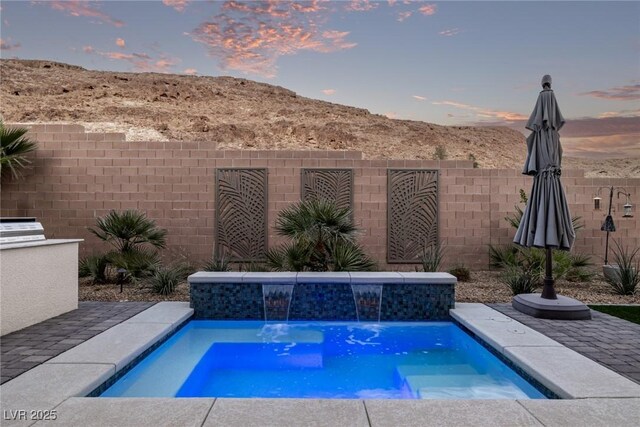 view of swimming pool featuring fence and a fenced in pool