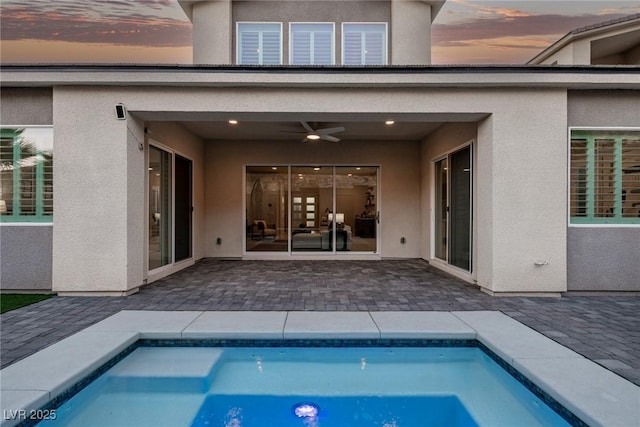 outdoor pool featuring ceiling fan and a patio