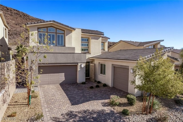 30 Hilltop Crest St, Henderson, NV 89011 - view of front of house featuring stucco siding, a tile roof, and decorative driveway