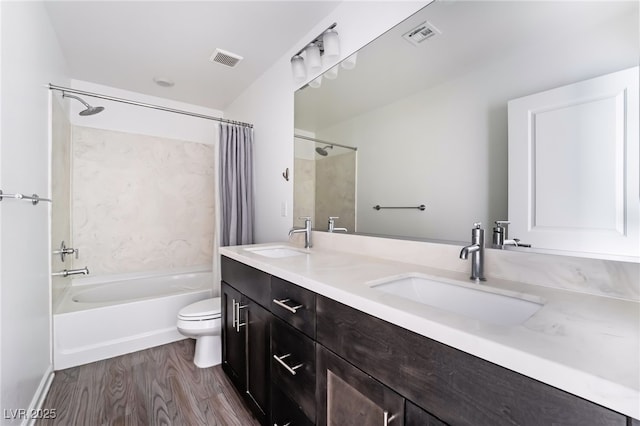 full bathroom featuring shower / bathtub combination with curtain, vanity, toilet, and hardwood / wood-style floors