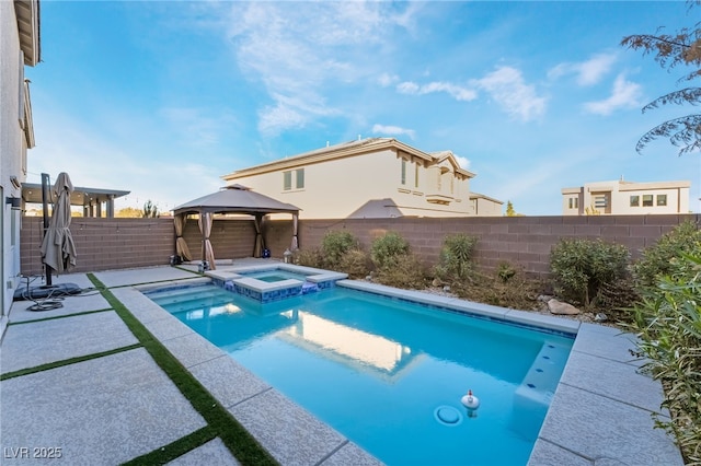 view of swimming pool featuring a gazebo and an in ground hot tub