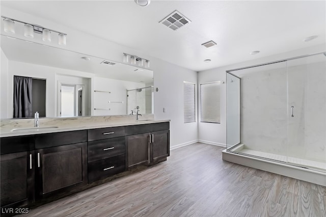 bathroom featuring vanity, a shower with shower door, and hardwood / wood-style floors