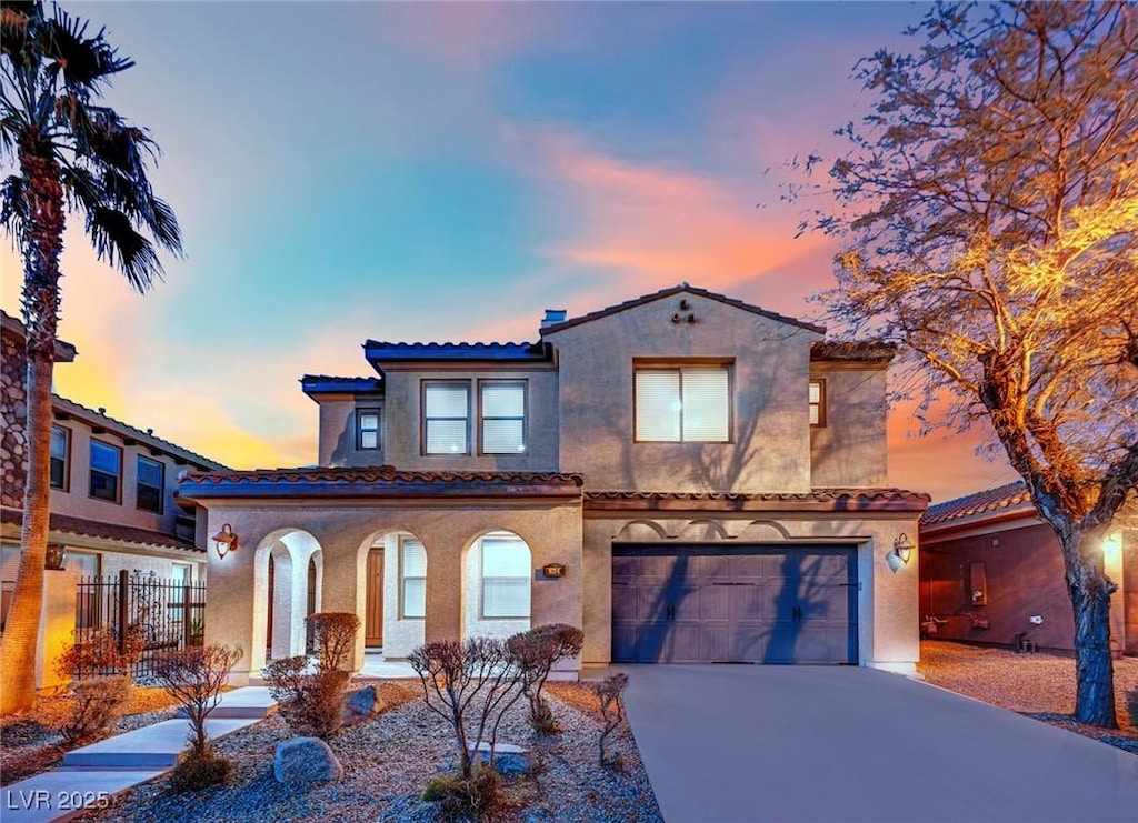 mediterranean / spanish house featuring a garage