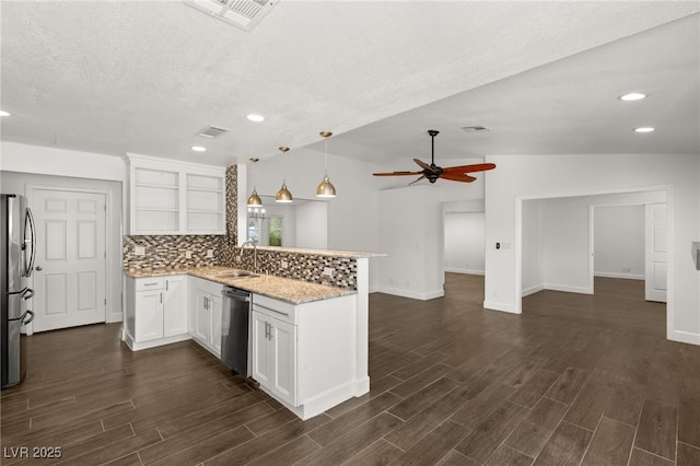 kitchen with backsplash, white cabinets, kitchen peninsula, and stainless steel appliances