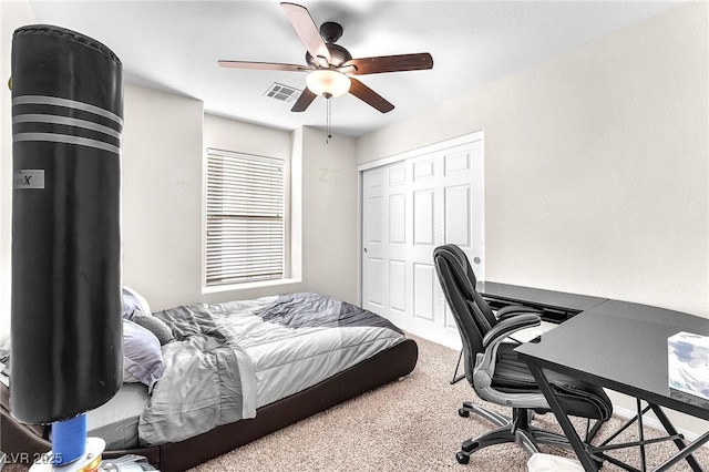 bedroom with carpet, ceiling fan, and a closet