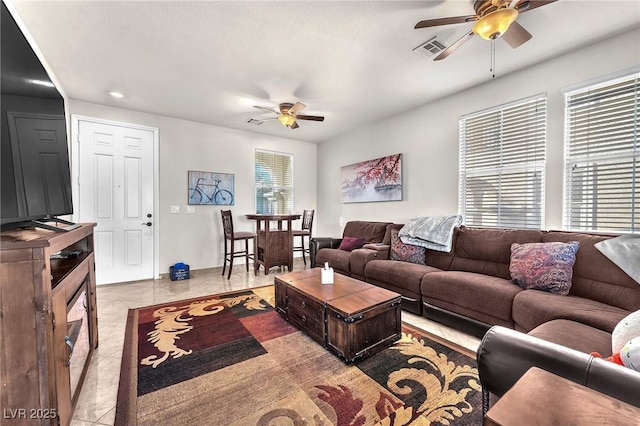 living room featuring light tile patterned floors and ceiling fan