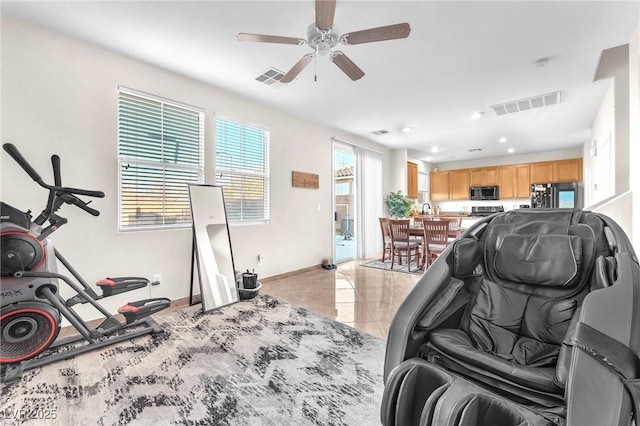 tiled living room with ceiling fan