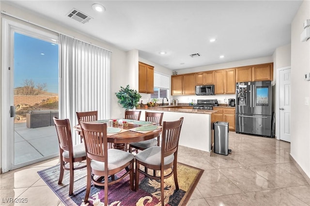 tiled dining space featuring sink