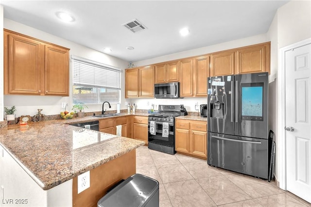 kitchen featuring light tile patterned flooring, sink, kitchen peninsula, stainless steel appliances, and light stone countertops