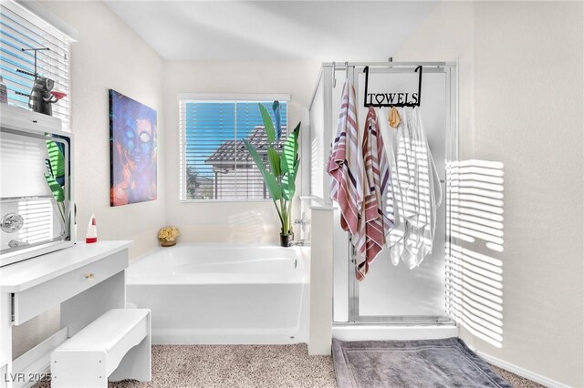 bathroom featuring shower with separate bathtub