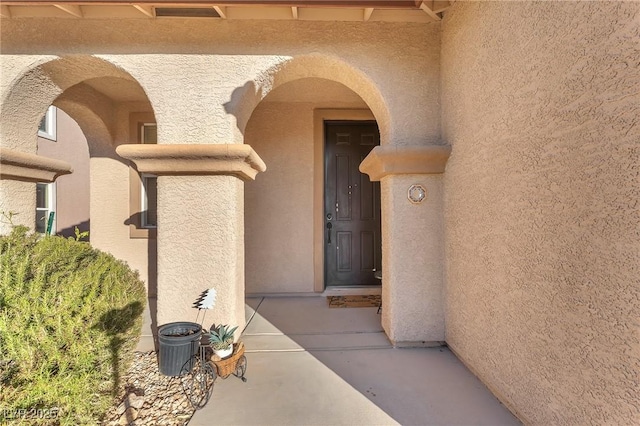 property entrance featuring a patio area