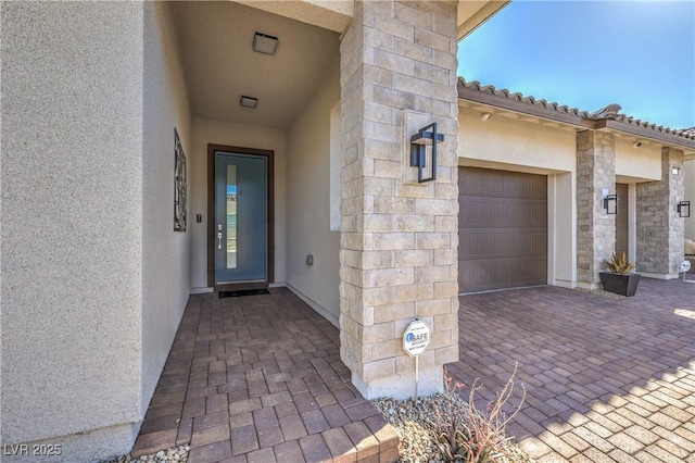 view of exterior entry featuring a garage