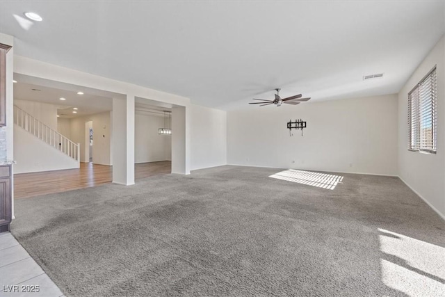 interior space with light carpet and ceiling fan