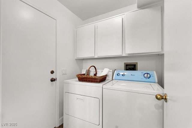 washroom featuring cabinets and separate washer and dryer