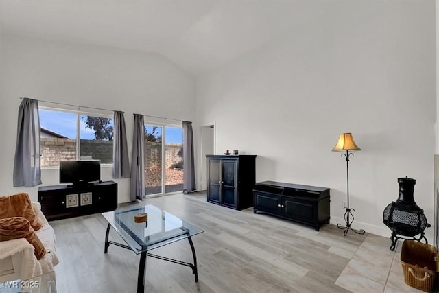 living room featuring light wood-type flooring and vaulted ceiling