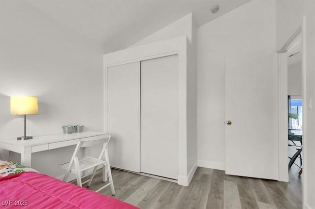 bedroom with light hardwood / wood-style flooring and a closet