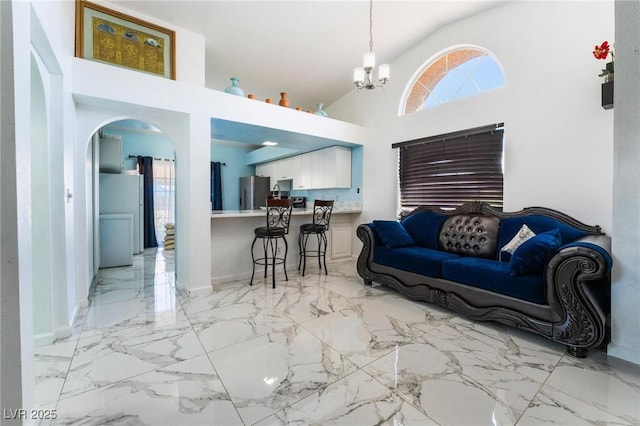 living room with a high ceiling and a notable chandelier