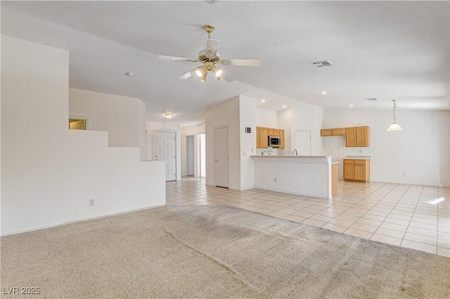 unfurnished living room featuring ceiling fan, lofted ceiling, and light tile patterned flooring