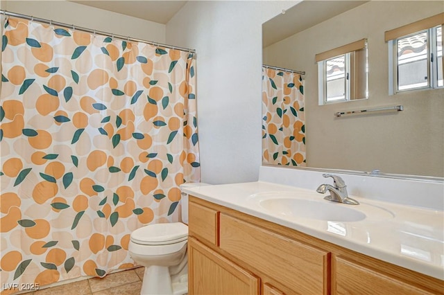 bathroom with vanity, toilet, and tile patterned flooring