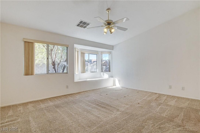 spare room with carpet floors and ceiling fan