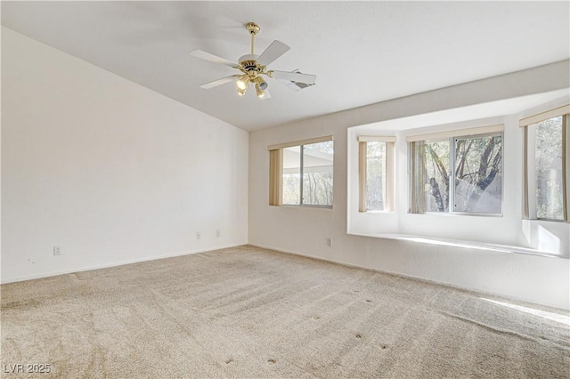 unfurnished room featuring carpet floors, plenty of natural light, and ceiling fan