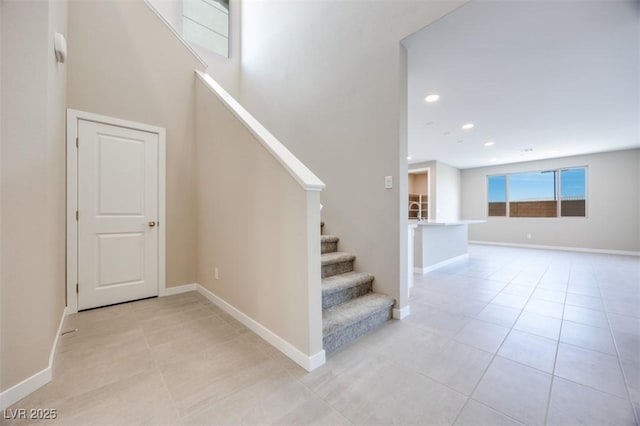 stairs featuring tile patterned flooring