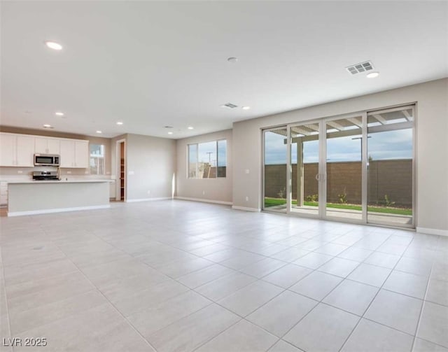 unfurnished living room with light tile patterned floors