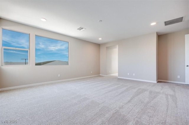 spare room featuring light colored carpet