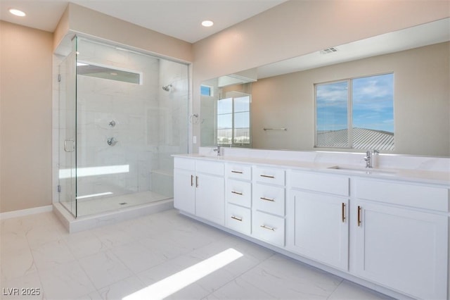 bathroom with a shower with door and vanity