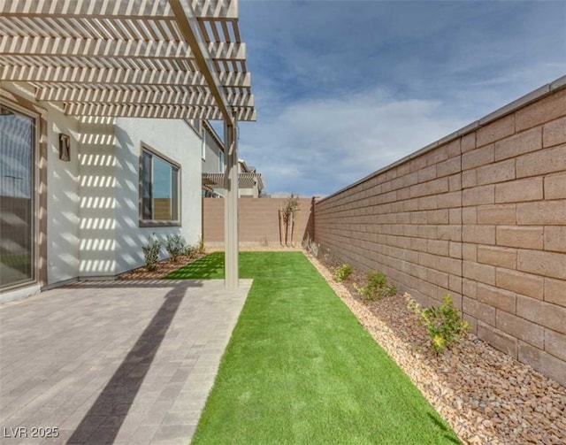 view of yard with a pergola and a patio area