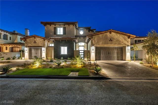 mediterranean / spanish-style house with a garage